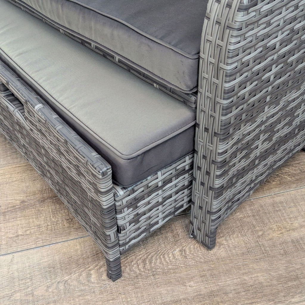 Close-up of hand-woven PE wicker on a chair with cushions.