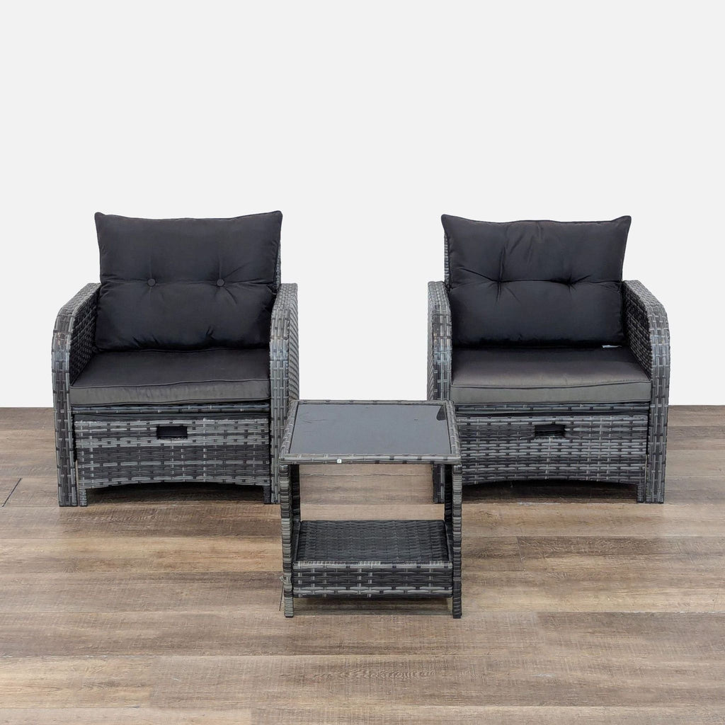 Set of two wicker chairs with cushions and a glass-top side table.