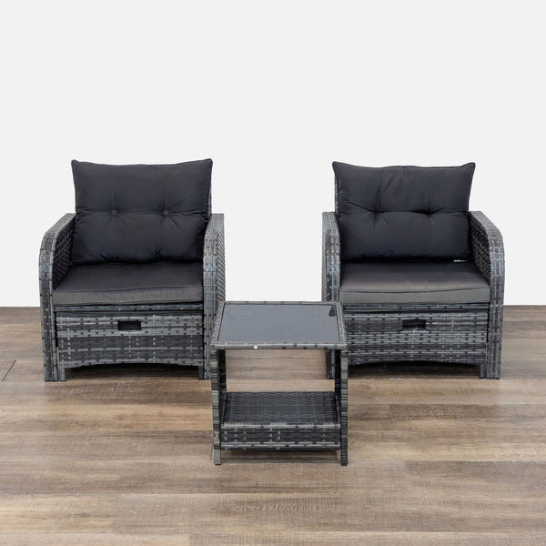 Set of two wicker chairs with cushions and a glass-top side table.