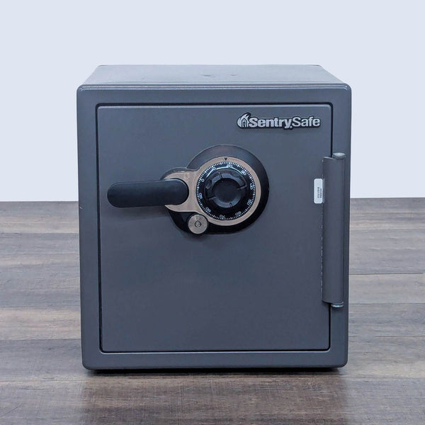Front view of a grey SentrySafe safe with a combination lock.