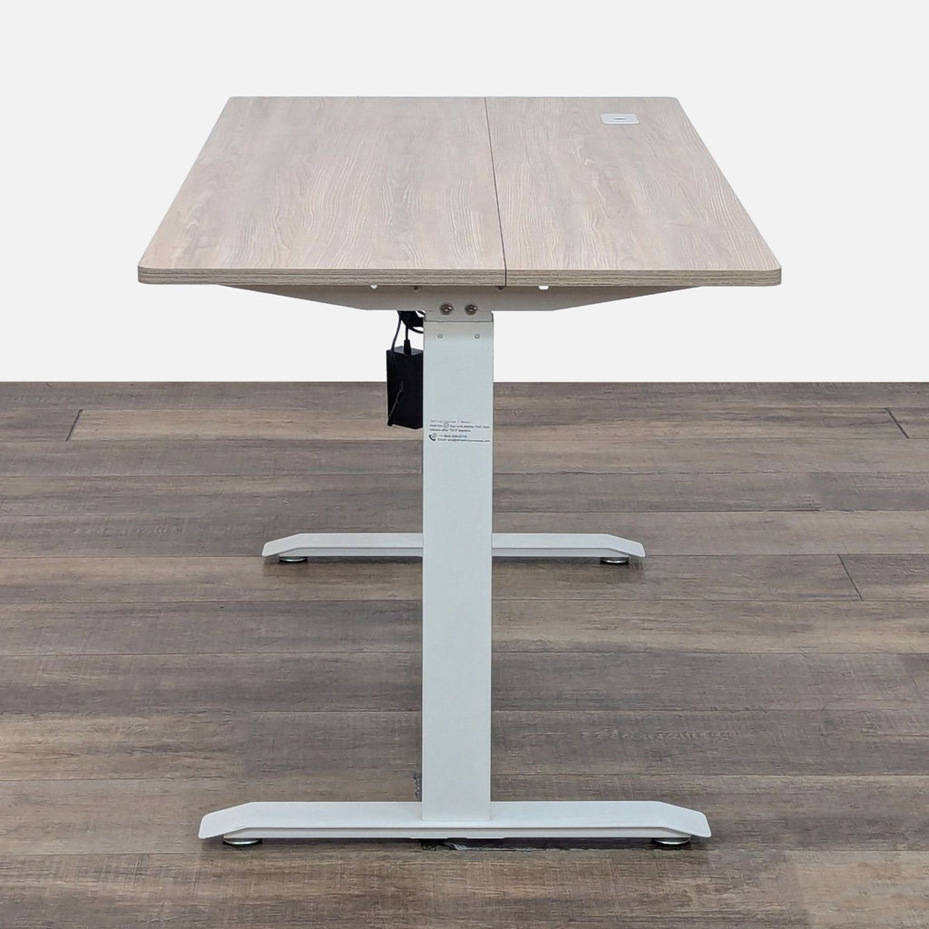 Side view of standing desk, light wood top, digital controls.