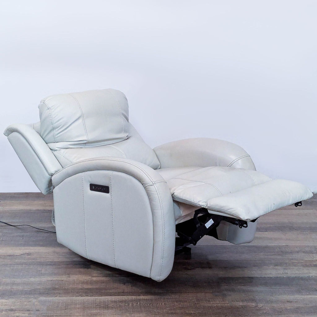 2. Side view of Reperch leather recliner in a reclined position, highlighting the adjustable headrest and USB port.