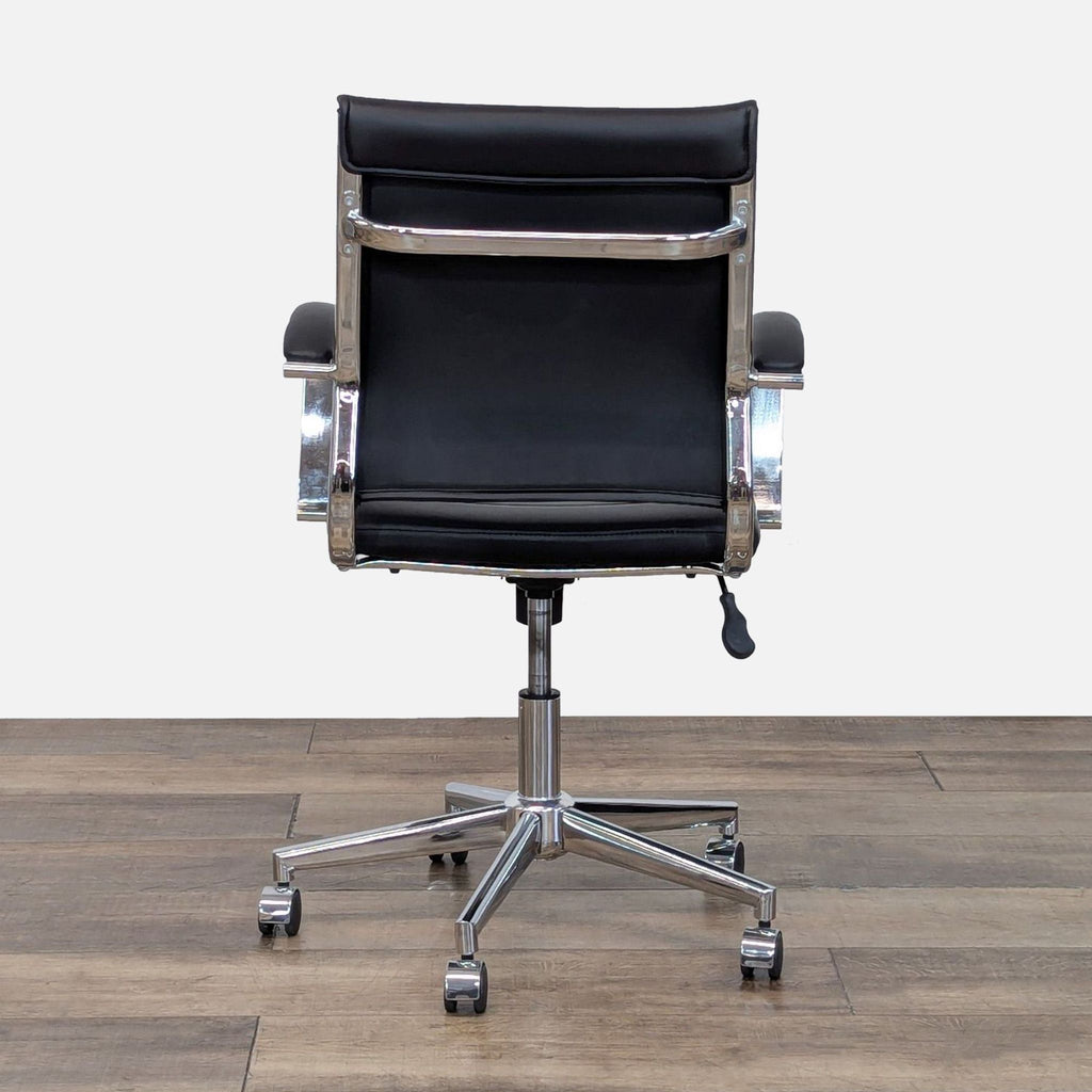 Rear view of a black chair with sturdy chrome base and wheels.