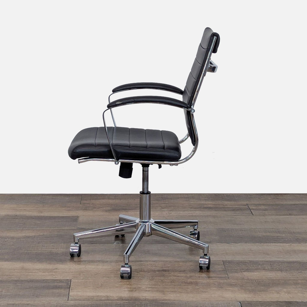 Side view of a black chair with adjustable height and chrome arms.