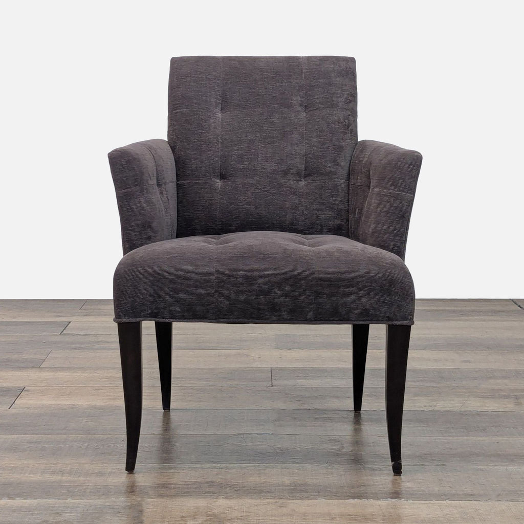 Front view of a Reperch lounge chair with flared arms, tufted upholstery, and dark tapered legs.
