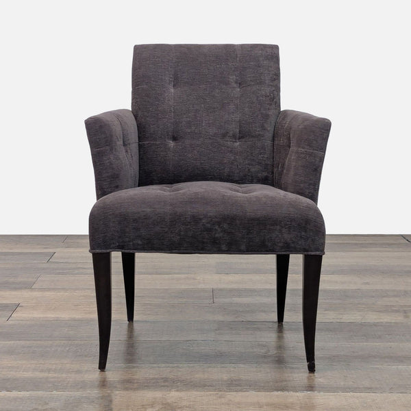 Front view of a dark gray Eaton chair with flared arms and tufted design.