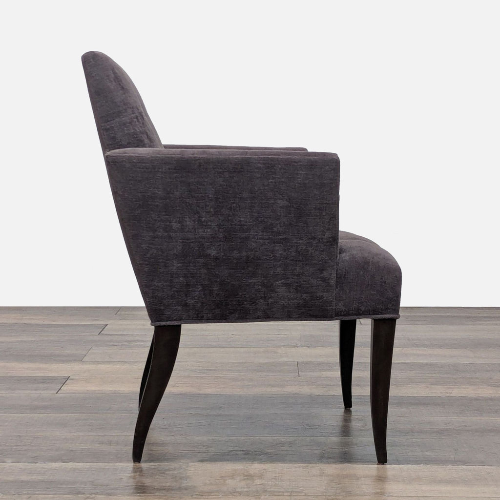 Side view of a gray lounge chair showcasing its sleek, tapered legs.