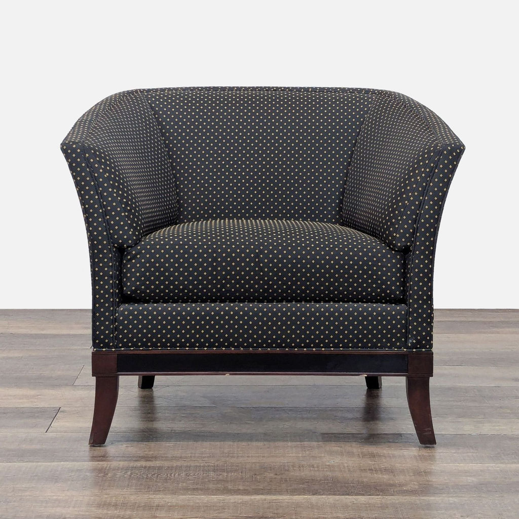 Front view of a lounge chair with black diamond-stitched upholstery and wood frame.