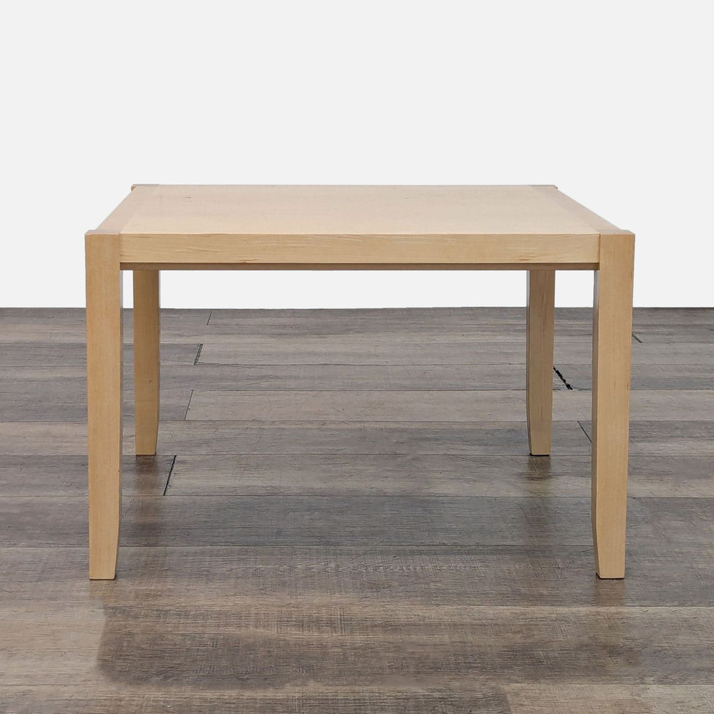 Reperch End Table in light wood finish on wooden floor. Simple and minimalist design.