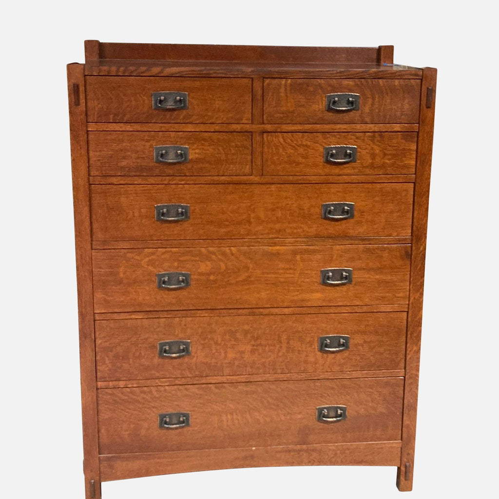 Stickley solid wood dresser with eight drawers and metal pulls.