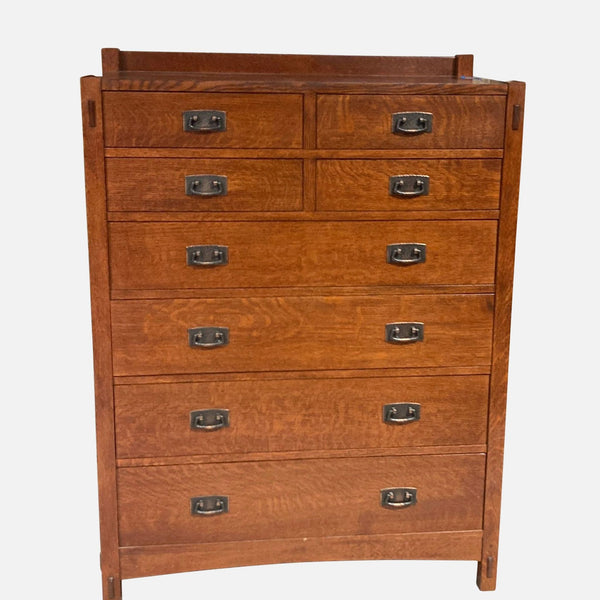 Stickley solid wood dresser with eight drawers and metal pulls.