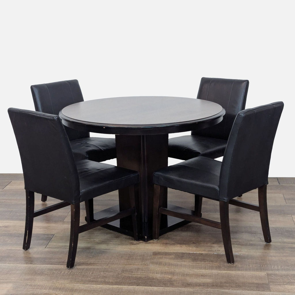 Reperch Dining Set: round table and four faux leather chairs, ideal for modern dining rooms.