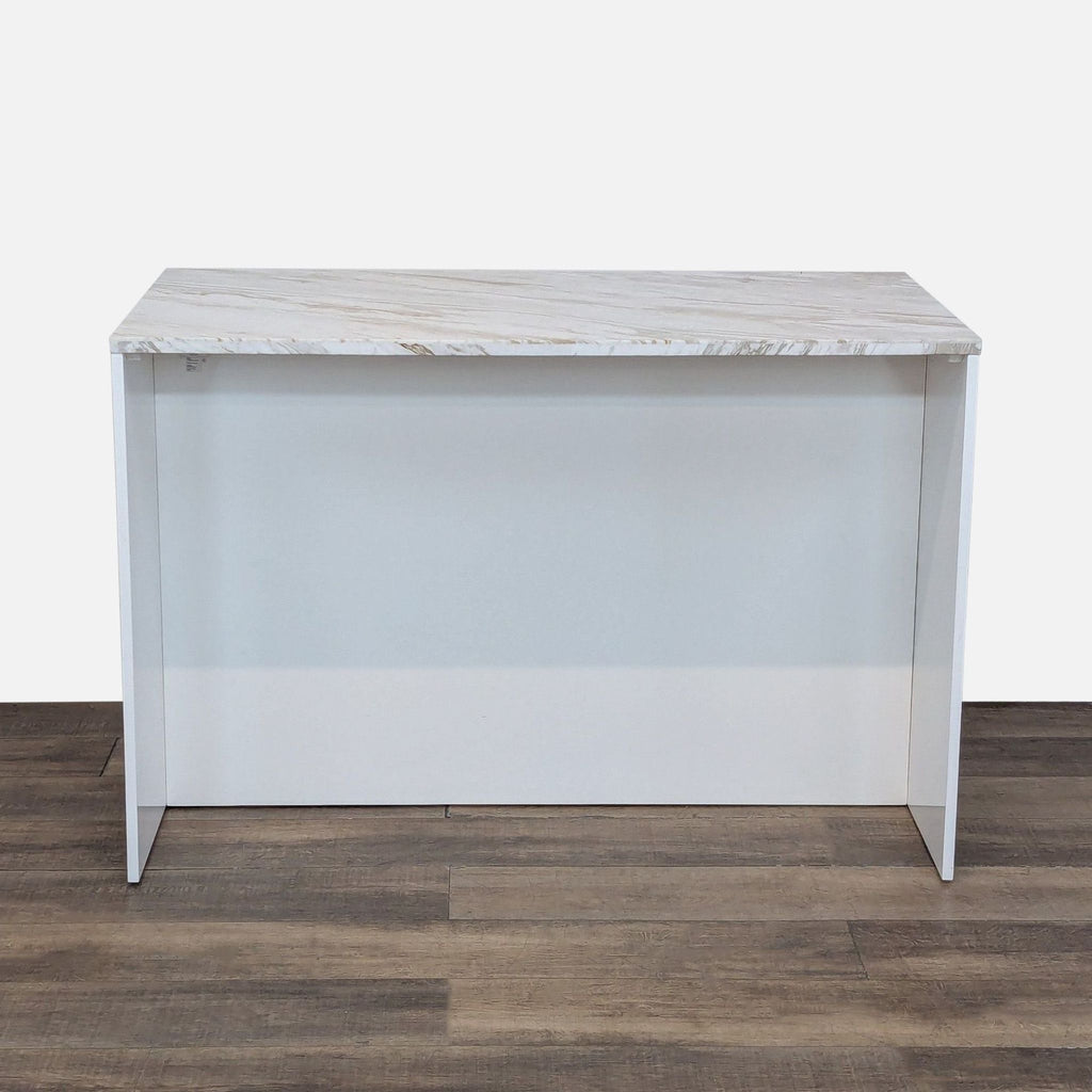 Back view of white kitchen island featuring a smooth, expansive marble surface.