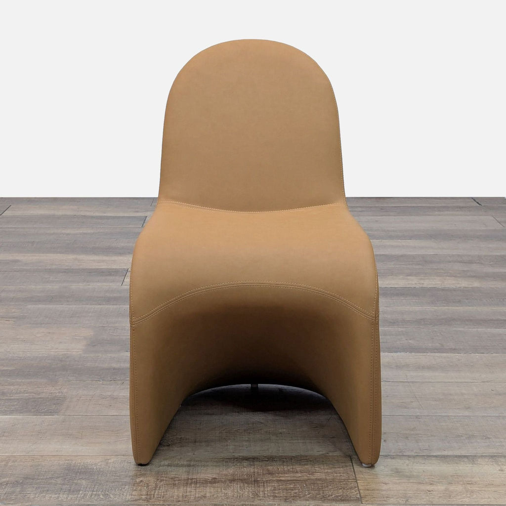 Front view of a tan chair with vegan leather upholstery and a welded steel frame.