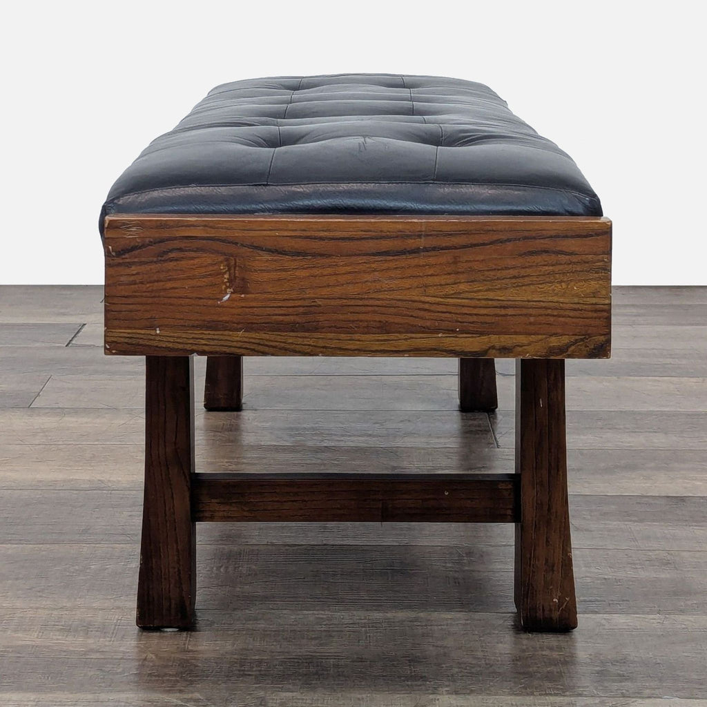 3. End view of a black and wooden bench by Room & Board.