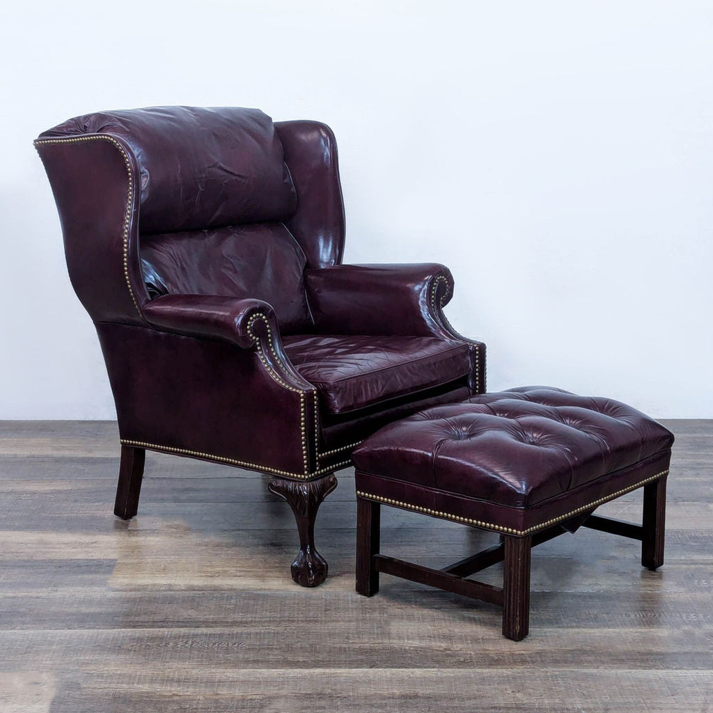 2. Burgundy lounge chair set, featuring brass nailhead trim and detailed carving.
