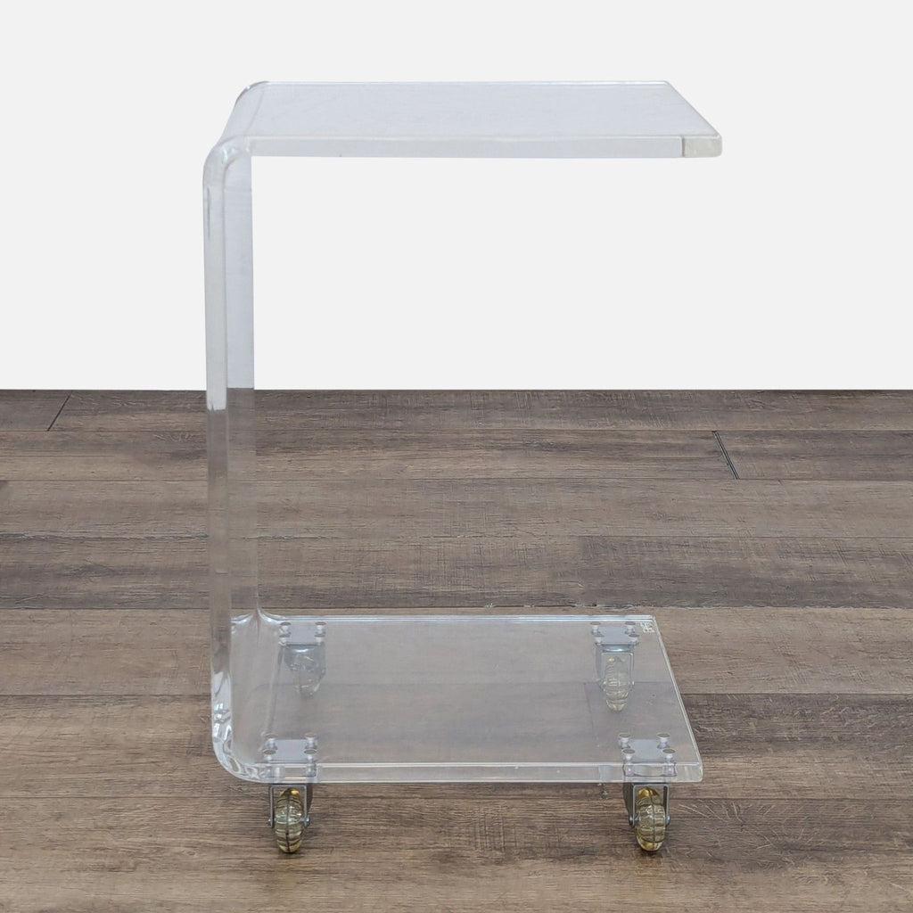 Transparent CB2 console table with sleek design and mobility.