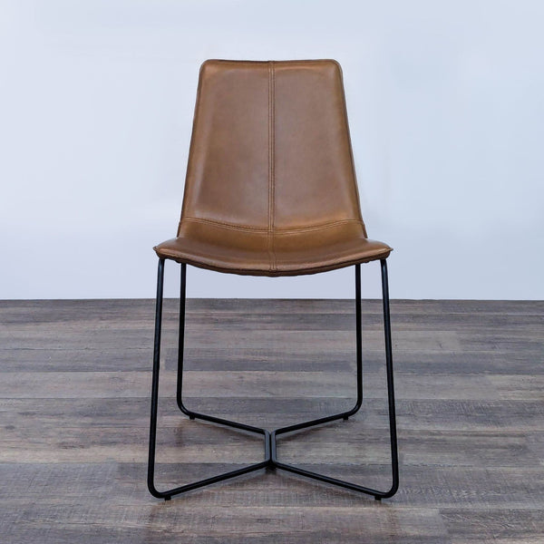 Front view of a brown leather dining chair with iron legs.  