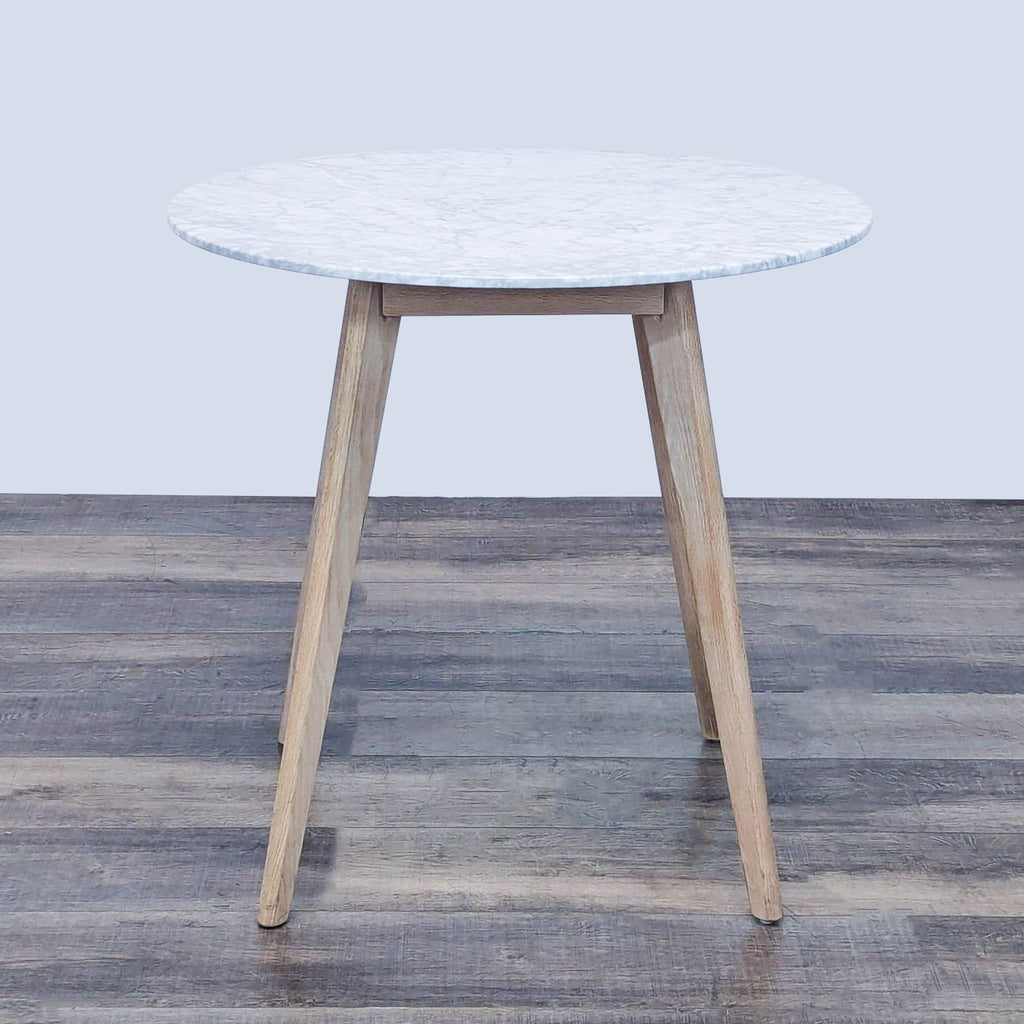 Marble top dining table with oak and engineered wood legs.