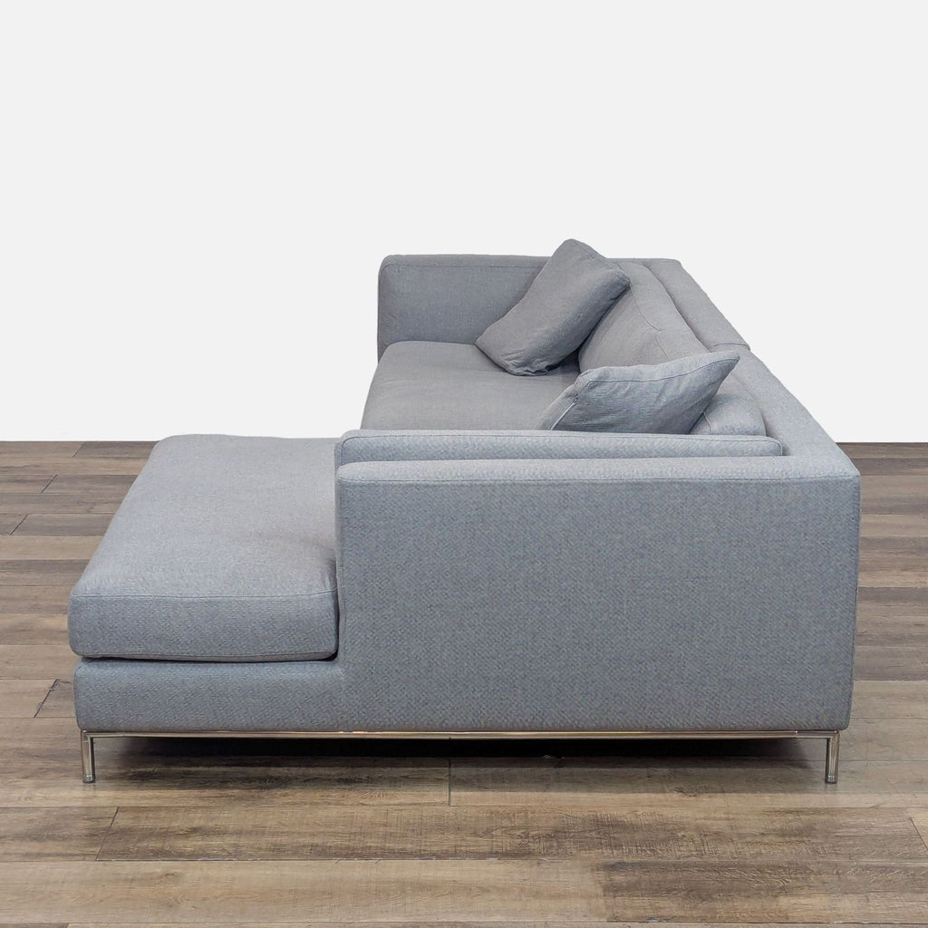 Side view of gray upholstered sectional with chaise.
