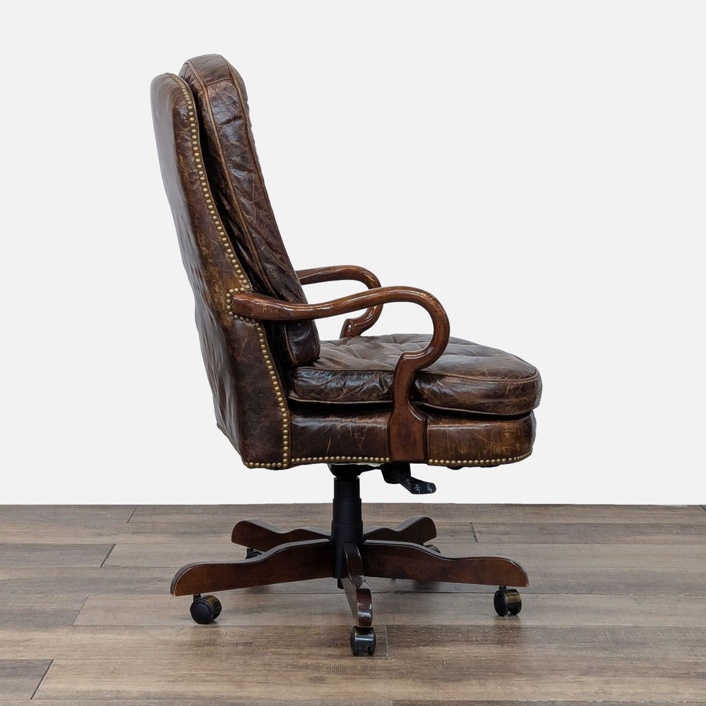 Side profile of a tufted leather chair by Century Furniture, with elegant wood arms.