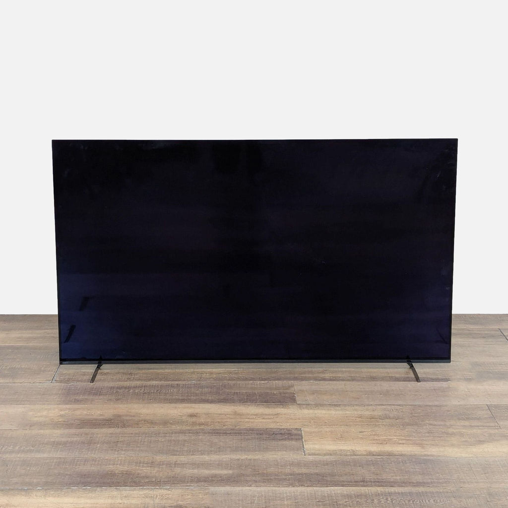 Side view of Sony 65-inch TV on wooden floor