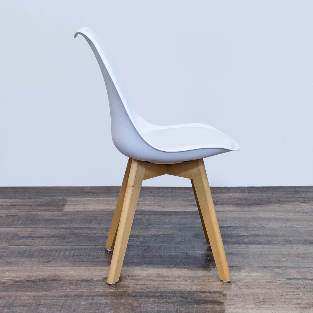 Profile of a Reperch chair with padded seat and wooden legs.