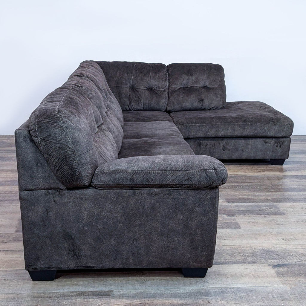 Side view of Ashley Furniture sectional with thick cushions and soft fabric.