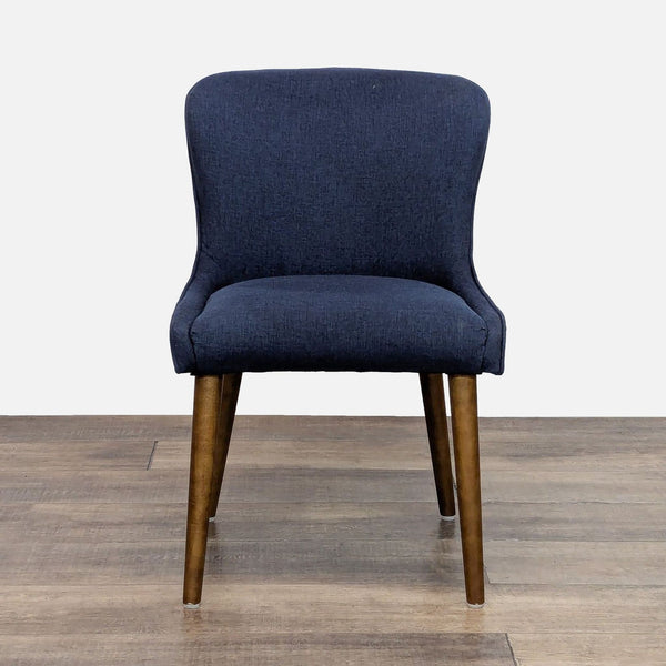 Front view of a blue upholstered dining chair with wooden legs.  