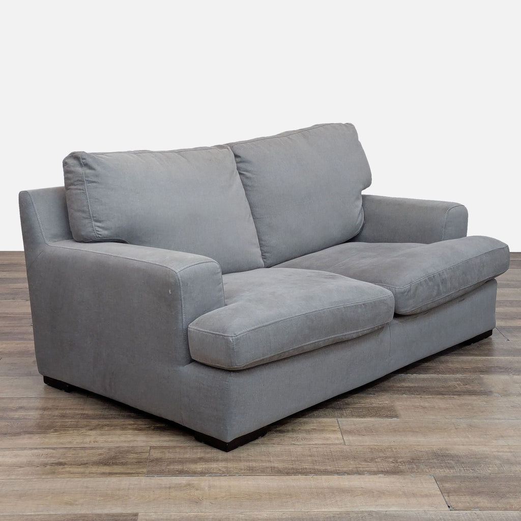 Angled view of Reperch loveseat, highlighting durable fabric and modern design.
