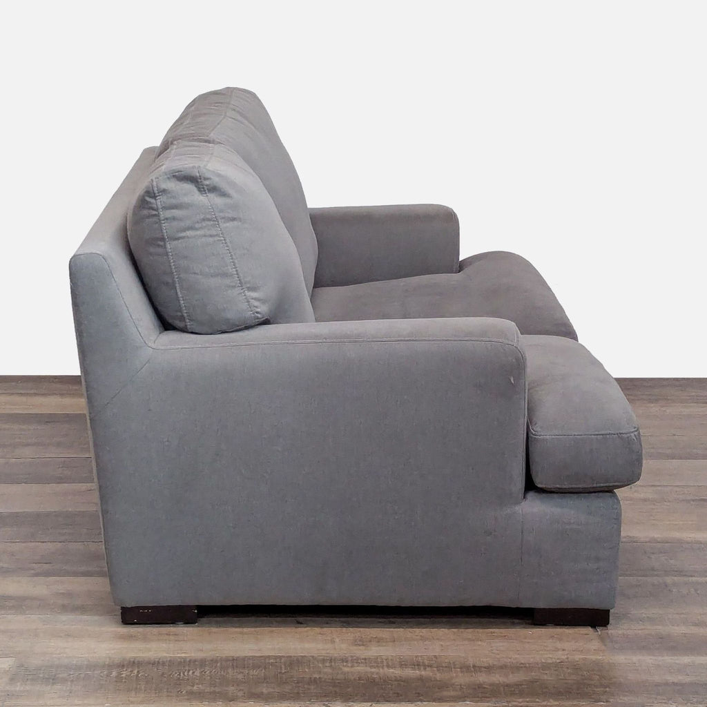 Side view of Reperch loveseat showcasing its simple silhouette.