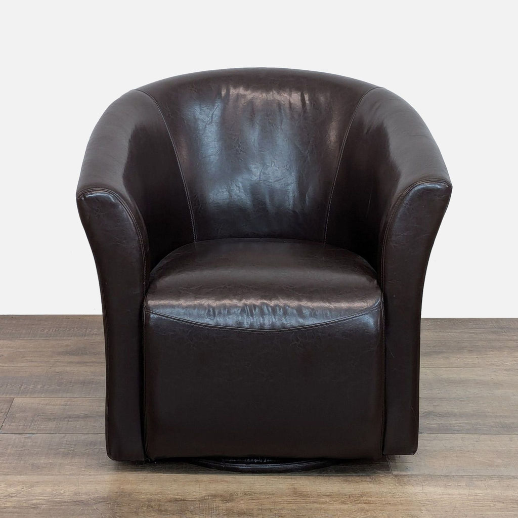Brown faux leather swivel lounge chair with barrel back on metal base.
