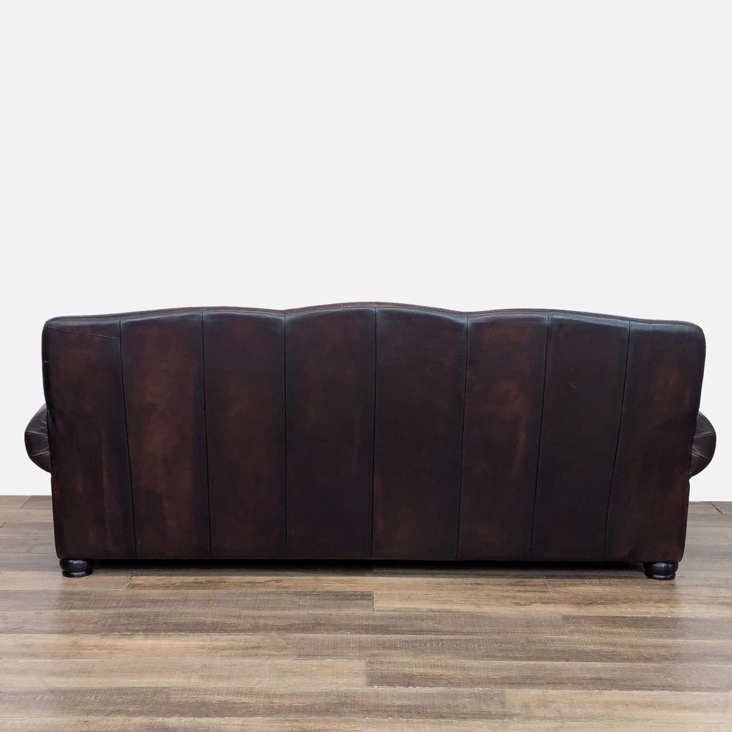 Back view of Reperch sofa in brown leather with smooth paneling.