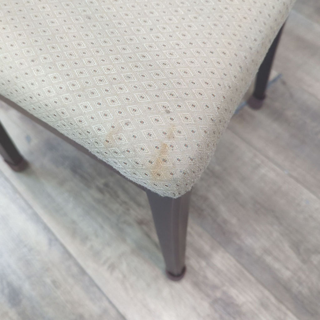 Close-up of upholstered chair seat in Reperch dining set.