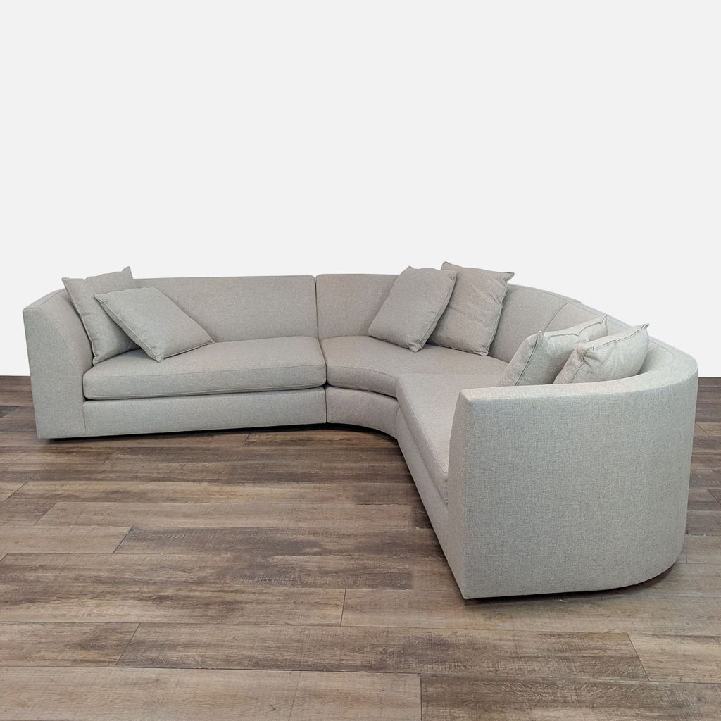 Astaire sectional by Room & Board features sink-in cushions and a modern curved shape.