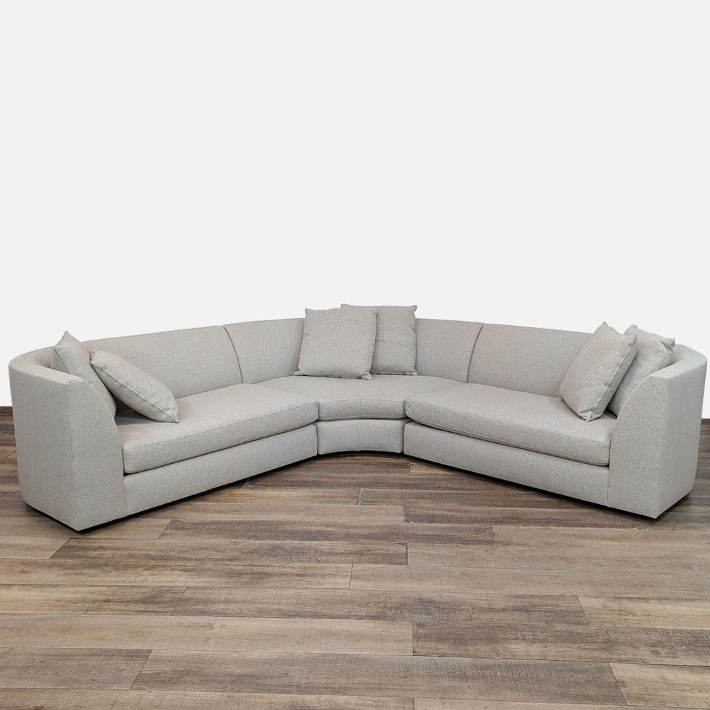 Room & Board Astaire sectional with curved design and loose back pillows for comfort.