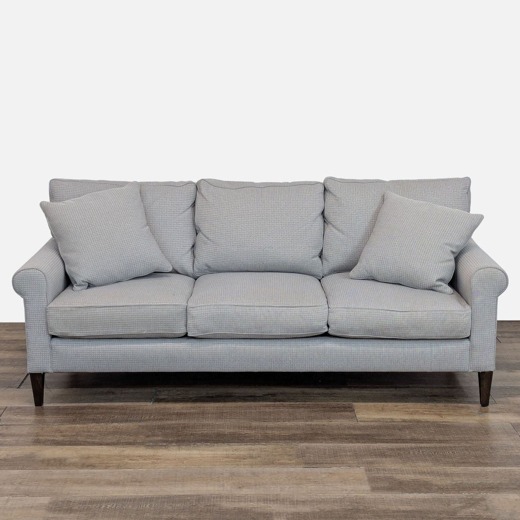 Reperch 3-seat sofa with loose back cushions and rolled arms in wool herringbone upholstery.