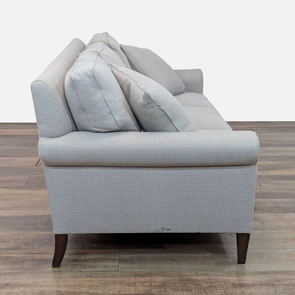 Side view of a Reperch 3-seat sofa featuring wood feet and wool herringbone fabric.