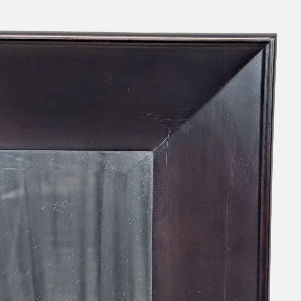 3. Close-up of the Reperch mirror’s dark, beveled frame corner highlighting wood texture and slight wear.