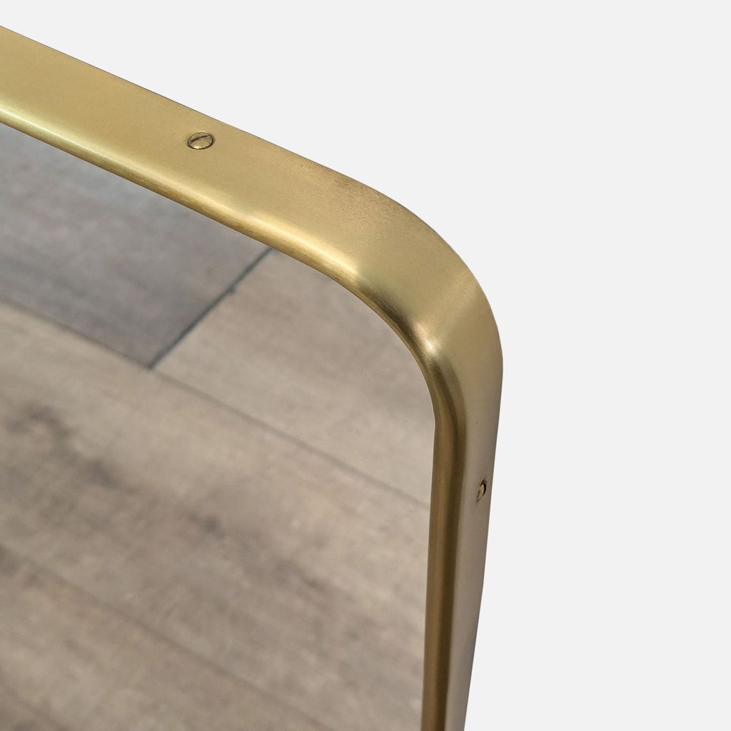 Close-up of the aged brass finish on a Rejuvenation mirror.