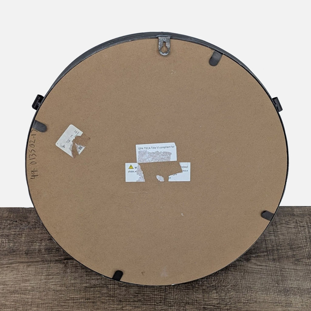 Back view of a round Reperch mirror showing mounting hardware.