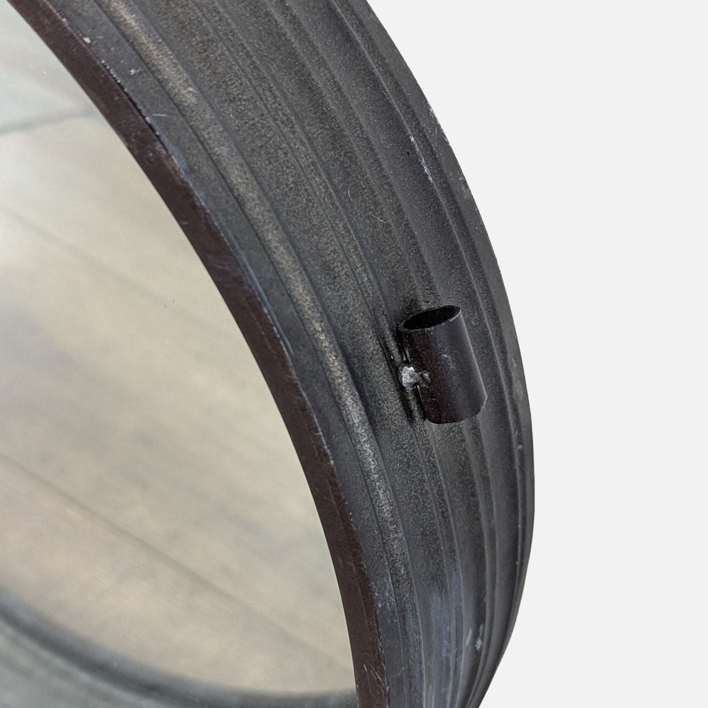 Close-up of the Reperch mirror's textured black metal frame.