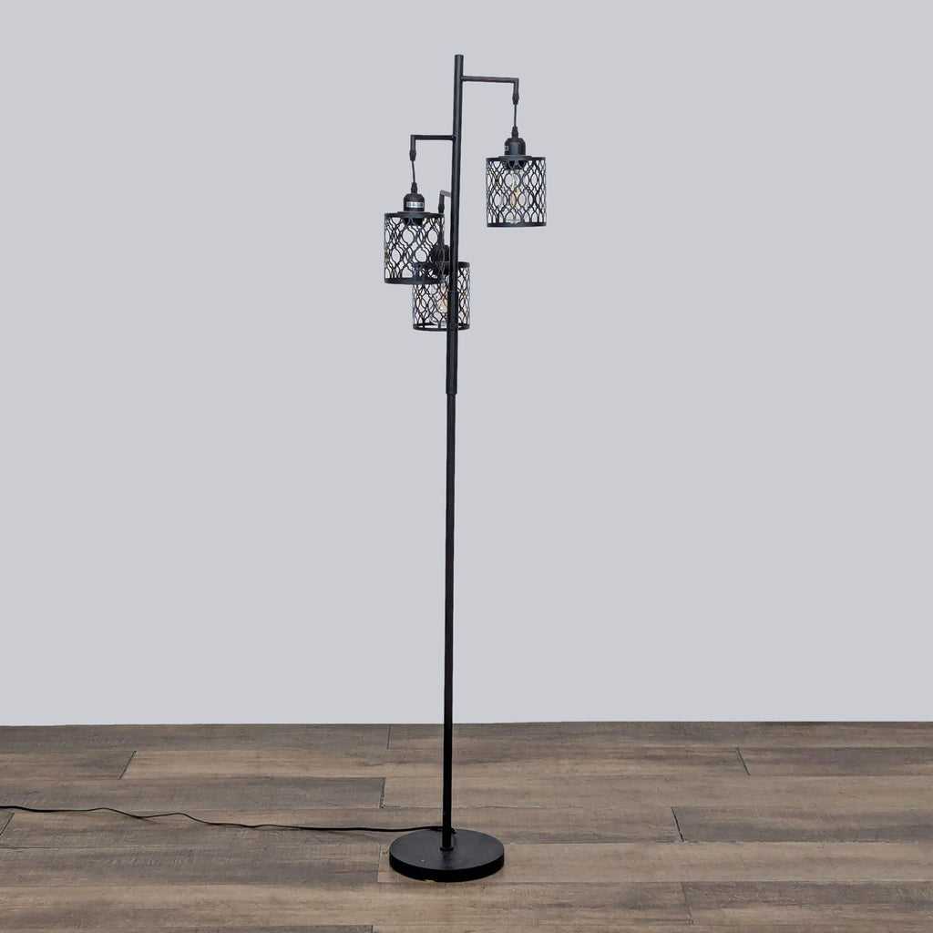 Side view of a ROTTOGOON floor lamp with three metal cage lights.
