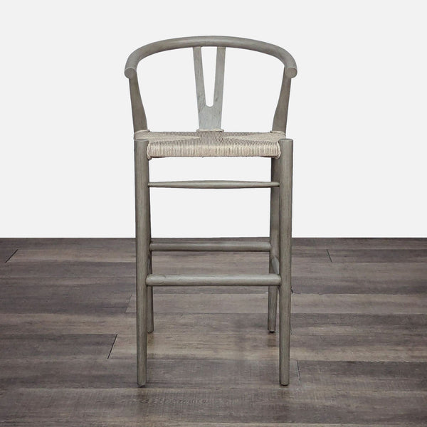 Mid-century style teak stool by Lulu & Georgia with a woven seat and a back cutout design.