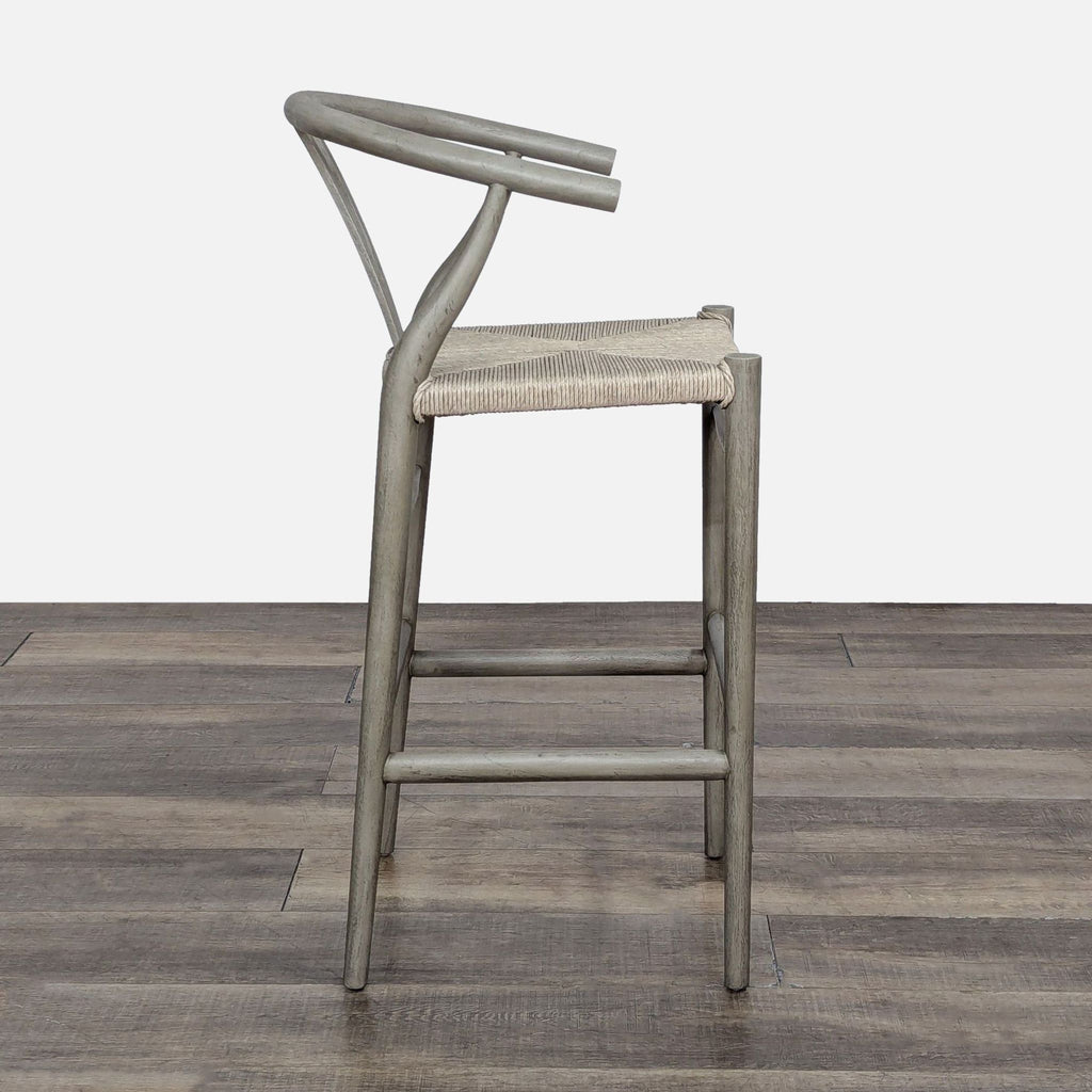 Mid-century inspired Lulu & Georgia stool in teak, showcasing a hand-woven seat and cutout back.