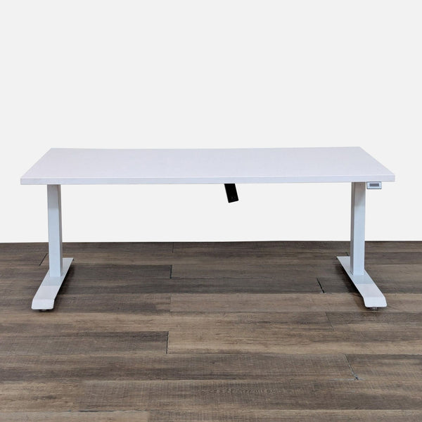 Sleek white desk with adjustable frame for sitting or standing use.