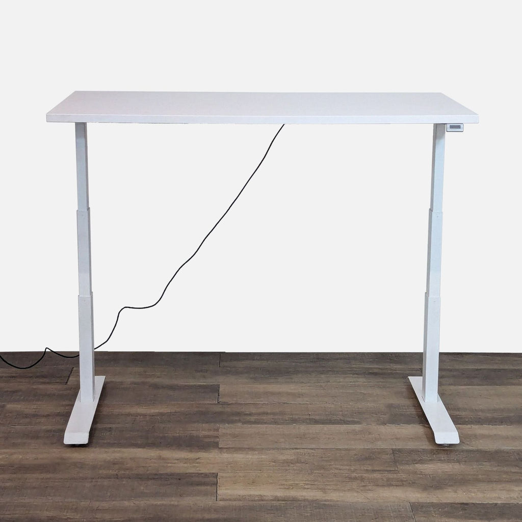 Adjustable white desk shown in standing position.
