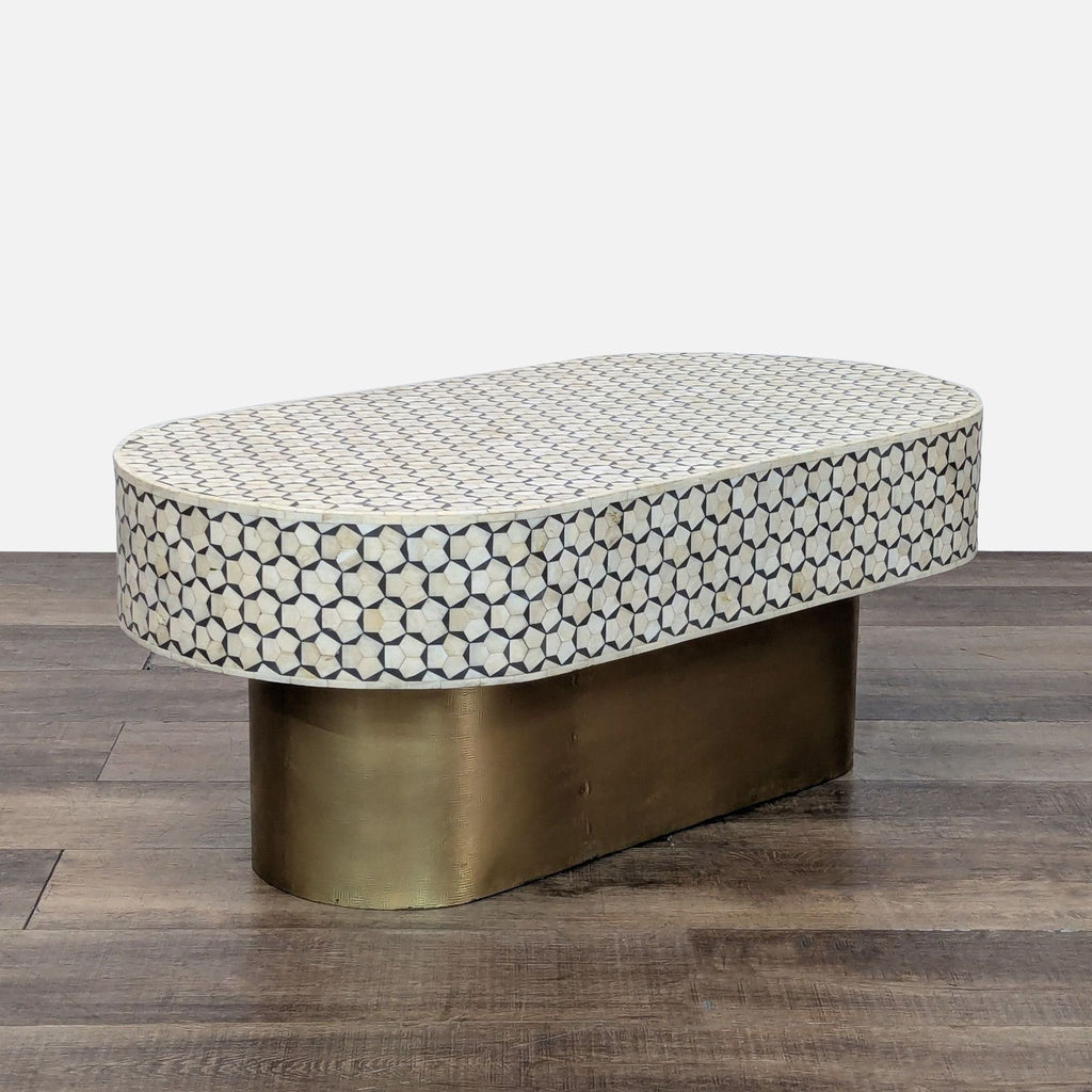 Side view of a designer table with brass base and bone inlay.
