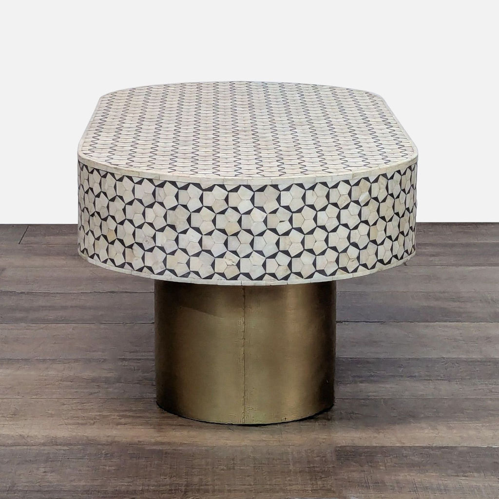 Front view of a modern coffee table with brass and inlay details.