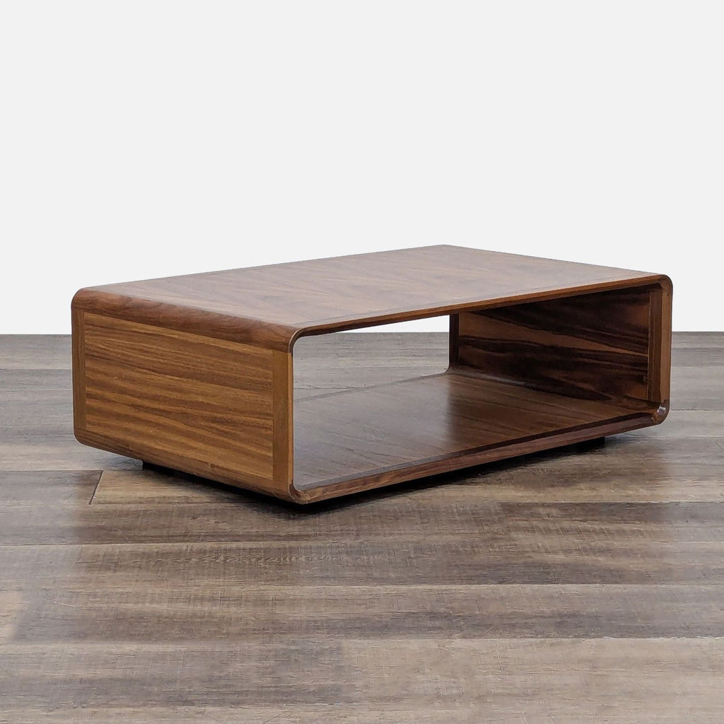 Side angle of a rectangular walnut coffee table by Floyd Home on wood flooring.